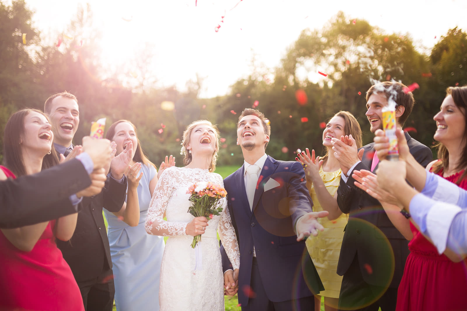 A newlywed couple and friends at a wedding
